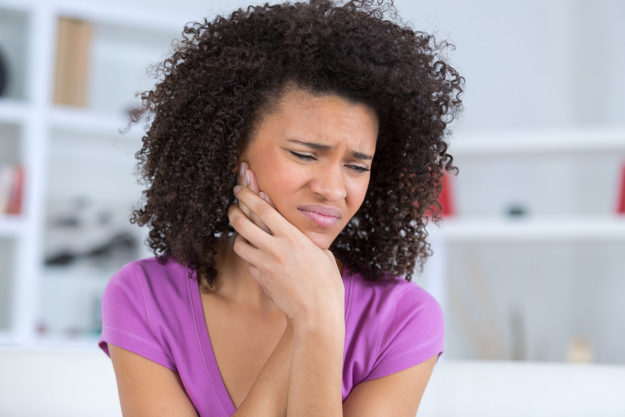 how does tooth decay develop (1) woman in pain wondering how does tooth decay develop