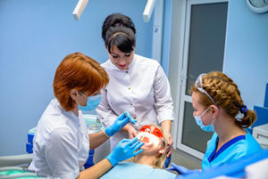 professionals performing oral surgery