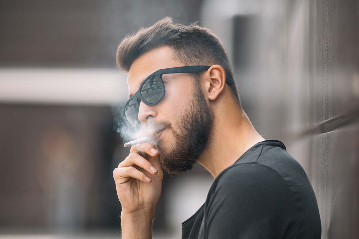man smoking Causes of Receding Gums
