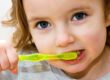 small child brushing teeth for oral health