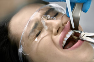 woman getting a tooth extraction 