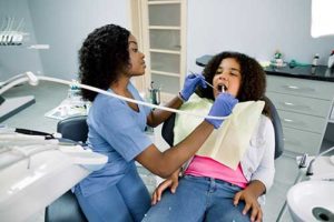 young woman gets a dental exam