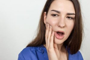 woman struggles with teeth grinding 