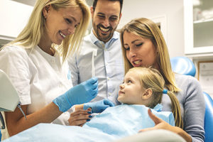 parents with daughter learning about family dentistry